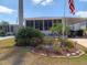 Charming home with lush landscaping and an American flag proudly displayed at 603 Leisure, Venice, FL 34285