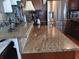 Stylish kitchen with a granite countertop and stainless steel refrigerator at 603 Leisure, Venice, FL 34285