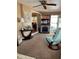 Cozy living room featuring a fireplace, recliner chair, neutral carpet, and lots of natural light at 603 Leisure, Venice, FL 34285