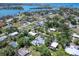 An aerial view of the property in a residential area with private backyard, lush trees, and a pool at 607 Bay Point Ave, Nokomis, FL 34275