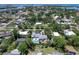 An aerial view showcasing a property with a private backyard oasis including lush landscaping and a sparkling pool at 607 Bay Point Ave, Nokomis, FL 34275