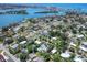 An aerial view shows the property in a residential area near the bay, featuring a private backyard and a pool at 607 Bay Point Ave, Nokomis, FL 34275