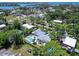 Aerial view of a home showcasing the private backyard oasis with a sparkling pool and lush landscaping at 607 Bay Point Ave, Nokomis, FL 34275