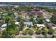 An aerial view shows a charming home with a circular driveway and a private backyard pool at 607 Bay Point Ave, Nokomis, FL 34275