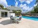 Beautiful backyard with a pool, patio, and umbrella, perfect for outdoor relaxation and entertainment at 607 Bay Point Ave, Nokomis, FL 34275