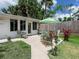Charming backyard patio area with comfortable seating, lush plants, and serene outdoor space at 607 Bay Point Ave, Nokomis, FL 34275