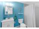 Bright bathroom featuring blue walls, a modern vanity, and a shower with a stylish shower curtain at 607 Bay Point Ave, Nokomis, FL 34275