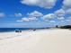 Beautiful sunny beach with white sand and clear blue sky with fluffy white clouds overhead at 607 Bay Point Ave, Nokomis, FL 34275