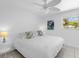 Bright bedroom with white walls, tile flooring, ceiling fan, and a large window with natural light at 607 Bay Point Ave, Nokomis, FL 34275