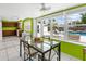 Bright dining area with view of the pool, modern furnishings, and lots of light at 607 Bay Point Ave, Nokomis, FL 34275