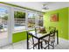 Inviting dining area with bright green walls and view of the pool and outdoor area at 607 Bay Point Ave, Nokomis, FL 34275