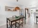 Dining room with modern lighting, view to stainless steel refrigerator and access to backyard at 607 Bay Point Ave, Nokomis, FL 34275