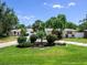 Lovely home with lush landscaping, mature trees, and a welcoming entrance, showcasing curb appeal at 607 Bay Point Ave, Nokomis, FL 34275