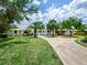 Charming home with a well-maintained lawn and long driveway leading to the beautiful property at 607 Bay Point Ave, Nokomis, FL 34275