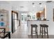 Kitchen with breakfast bar, stainless steel appliances, wood cabinets and tile flooring at 607 Bay Point Ave, Nokomis, FL 34275