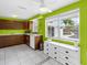 Bright kitchen featuring dark wood cabinets, white countertops, and stainless steel appliances at 607 Bay Point Ave, Nokomis, FL 34275
