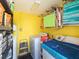 Functional laundry room with washer, dryer, storage shelves, and a water heater at 607 Bay Point Ave, Nokomis, FL 34275