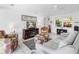 Inviting living room featuring a comfortable sofa, patterned armchairs, and modern entertainment center at 607 Bay Point Ave, Nokomis, FL 34275