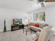 Inviting living room with tile flooring, comfortable seating and a large TV entertainment center at 607 Bay Point Ave, Nokomis, FL 34275