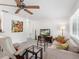 Cozy living room with neutral color scheme, comfortable seating, and ample natural light from the large windows at 607 Bay Point Ave, Nokomis, FL 34275