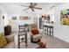 Open-concept living room, showcasing kitchen access, comfortable chair and tile flooring at 607 Bay Point Ave, Nokomis, FL 34275