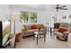 Bright living room featuring neutral tones, comfortable seating, and a serene view to the outside at 607 Bay Point Ave, Nokomis, FL 34275