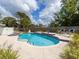 Relaxing backyard oasis with a sparkling pool and spa, surrounded by lush landscaping and comfortable seating at 607 Bay Point Ave, Nokomis, FL 34275