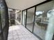 Balcony featuring sliding glass doors and tile floor with screened enclosure at 618 Bird Bay S Dr # 212, Venice, FL 34285