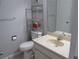 Cozy bathroom featuring a vanity, toilet, shelving unit, and neutral wall color at 618 Bird Bay S Dr # 212, Venice, FL 34285