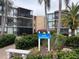 Exterior view of the Sandpiper condos with palm trees and lush landscaping at 618 Bird Bay S Dr # 212, Venice, FL 34285