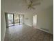 Open living room featuring tile floors, sliding glass doors to balcony, and neutral paint at 618 Bird Bay S Dr # 212, Venice, FL 34285