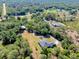 Expansive aerial view of home nestled within lush greenery and mature trees, offering privacy at 6293 Taneytown St, North Port, FL 34291