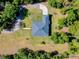 Aerial view of home with sprawling lot and mature trees, showcasing a serene country setting at 6293 Taneytown St, North Port, FL 34291