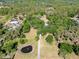 Overhead aerial view of a property with long driveway, water feature, and lush surroundings at 6293 Taneytown St, North Port, FL 34291