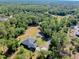 Panoramic aerial view of home surrounded by lush greenery, offering unparalleled privacy and tranquility at 6293 Taneytown St, North Port, FL 34291