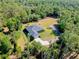Beautiful aerial view of a private home surrounded by lush trees, nestled in a serene landscape at 6293 Taneytown St, North Port, FL 34291