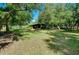 Expansive backyard featuring mature trees, offering a serene space to enjoy nature at 6293 Taneytown St, North Port, FL 34291
