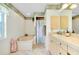 Bathroom featuring a soaking tub, patterned wallpaper, and a single-sink vanity with ample cabinet space at 6293 Taneytown St, North Port, FL 34291