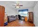 Bright bedroom featuring hardwood floors, ceiling fan, and natural light from the window at 6293 Taneytown St, North Port, FL 34291