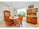 The dining room features tile flooring and a decorative light fixture hanging over the wooden table at 6293 Taneytown St, North Port, FL 34291