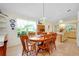 Bright dining area features an ornamental hanging light fixture and views of the landscaped yard at 6293 Taneytown St, North Port, FL 34291