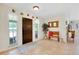Inviting entryway boasts tile floors, a wooden bench, and natural light from adjacent windows at 6293 Taneytown St, North Port, FL 34291