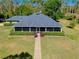 Charming home with screened porch, manicured hedges, and a brick walkway leading to the front door at 6293 Taneytown St, North Port, FL 34291