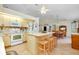 Eat-in kitchen with island, light wood cabinets, and modern appliances at 6293 Taneytown St, North Port, FL 34291