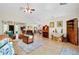 Large open-concept space connecting the entryway, living, and dining areas with neutral tile floors at 6293 Taneytown St, North Port, FL 34291