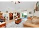 Cozy living room with tile flooring, a comfortable sofa, and a view to the outdoors at 6293 Taneytown St, North Port, FL 34291