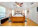 Large main bedroom with wood floors, ceiling fan, and natural light coming through the windows at 6293 Taneytown St, North Port, FL 34291