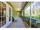 Screened porch with two chairs and a ceiling fan at 6293 Taneytown St, North Port, FL 34291