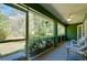 Relaxing screened porch with verdant view and inviting seating area, perfect for enjoying the outdoors at 6293 Taneytown St, North Port, FL 34291