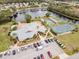 Aerial view showcases the community amenities including the pool, clubhouse, and tennis courts at 657 Foxwood Blvd, Englewood, FL 34223